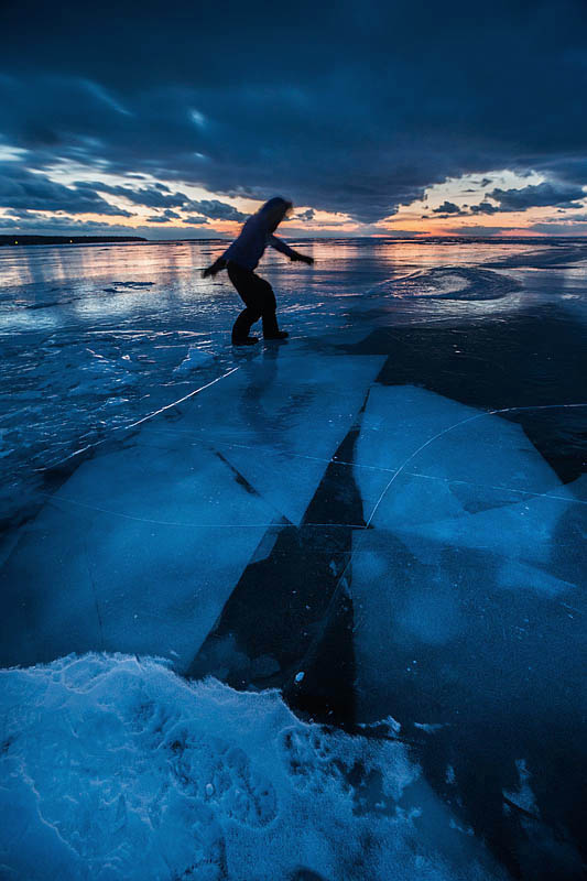 My sister walking across the ice at night