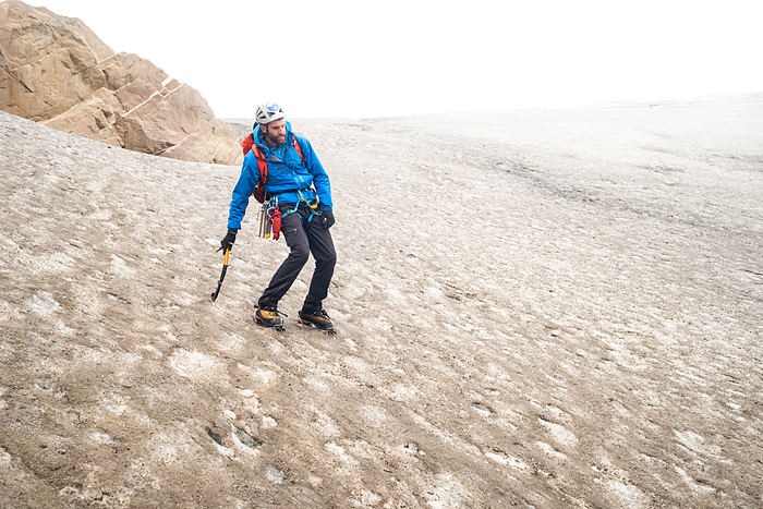 Guide demonstrating the cowboy slouch a necessary postion when descending glacial ice 