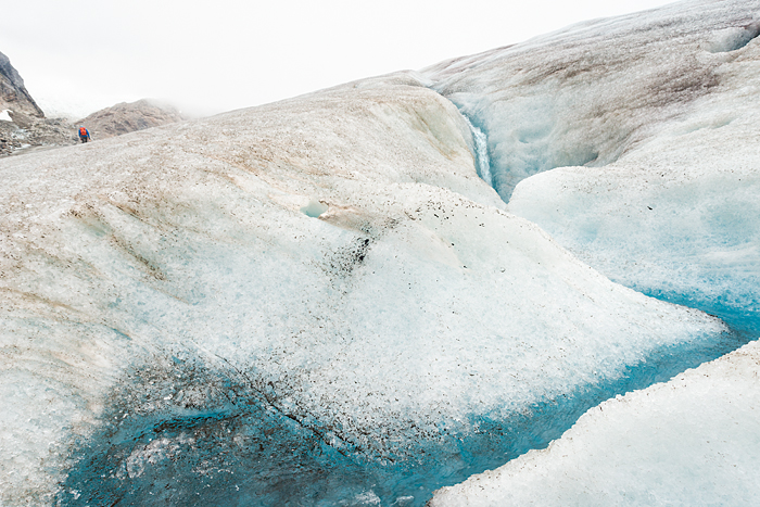 Guide disappears into an icy landscape on Lemon Glacier, Juneau Icefield, Juneau, Alaska, 