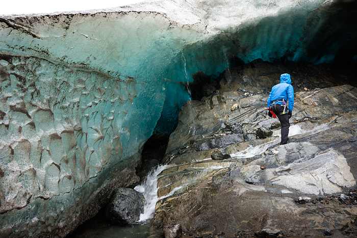 man explores ice cave, Trekking adventure on Lemon Glacier, Juneau Icefield, Juneau, Alaska, USA