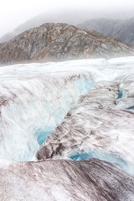 icy landscape on glacier, Campsite of tent in glacier valley with mineral lake and waterfall at Lemon Glacier, Juneau Icefield, Juneau, Alaska, USA