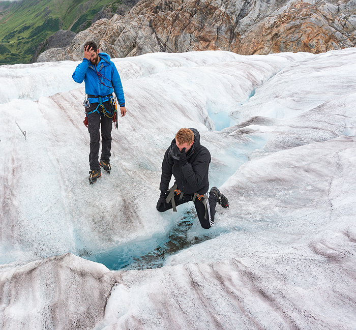 polar plunge in glacier water, Man jumps over crevasse while trekking adventure on Lemon Glacier, Juneau Icefield, Juneau, Alaska, USA