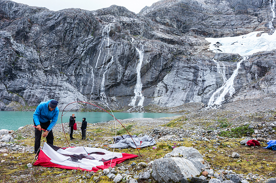 couple tent camping on glacier, walking on glacier ice, Juneau, Alaska