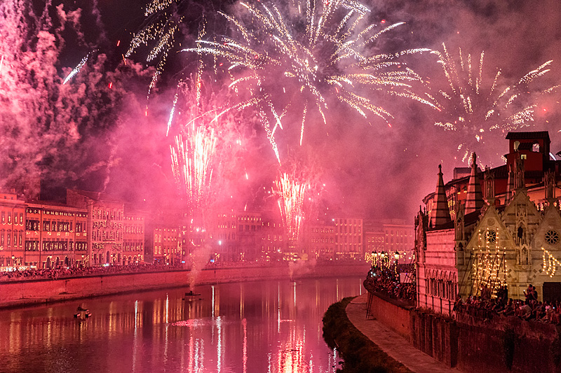 Pisa Luminara festival fireworks over Arno River