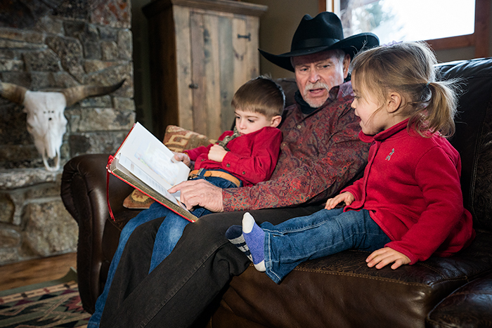 life-on-a-ranch-cowboy-culture-grandpa-reading-kids