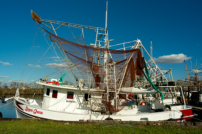 Shrimp boats and repairing fishing net, Delcambre, Acadia, Louisiana, USA