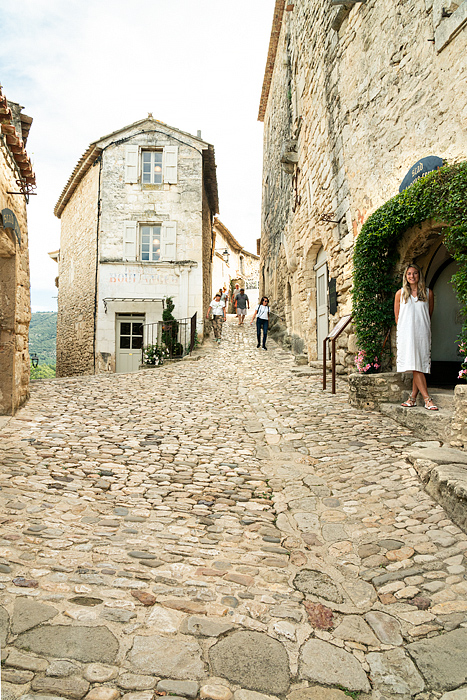 SCAD student stands near the Boulangerie, Lacoste village, Provence, France